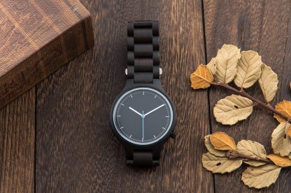 Black dial watch with white and blue hands