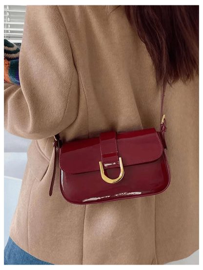 Burgundy patent leather buckled underarm bag