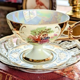 Gilded hand-painted bone china cup and saucer set