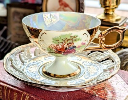Gilded hand-painted bone china cup and saucer set