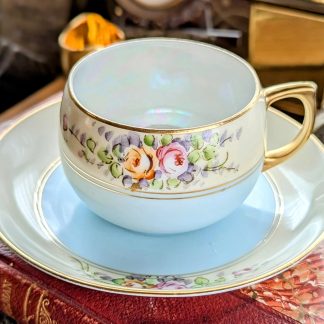 Glazed hand-painted floral cluster cup and saucer set