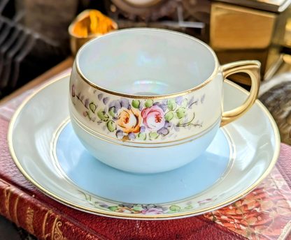 Glazed hand-painted floral cluster cup and saucer set