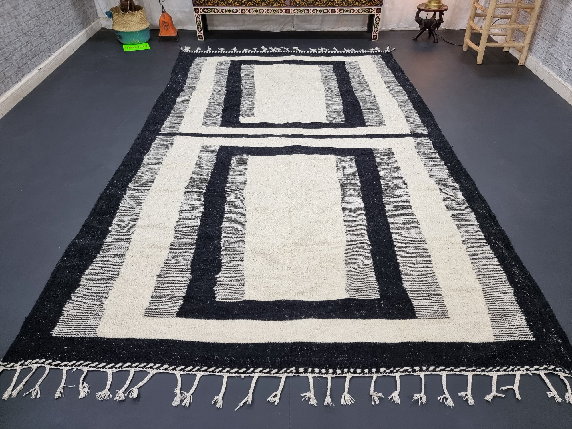 Handmade black and white geometric tassel rug