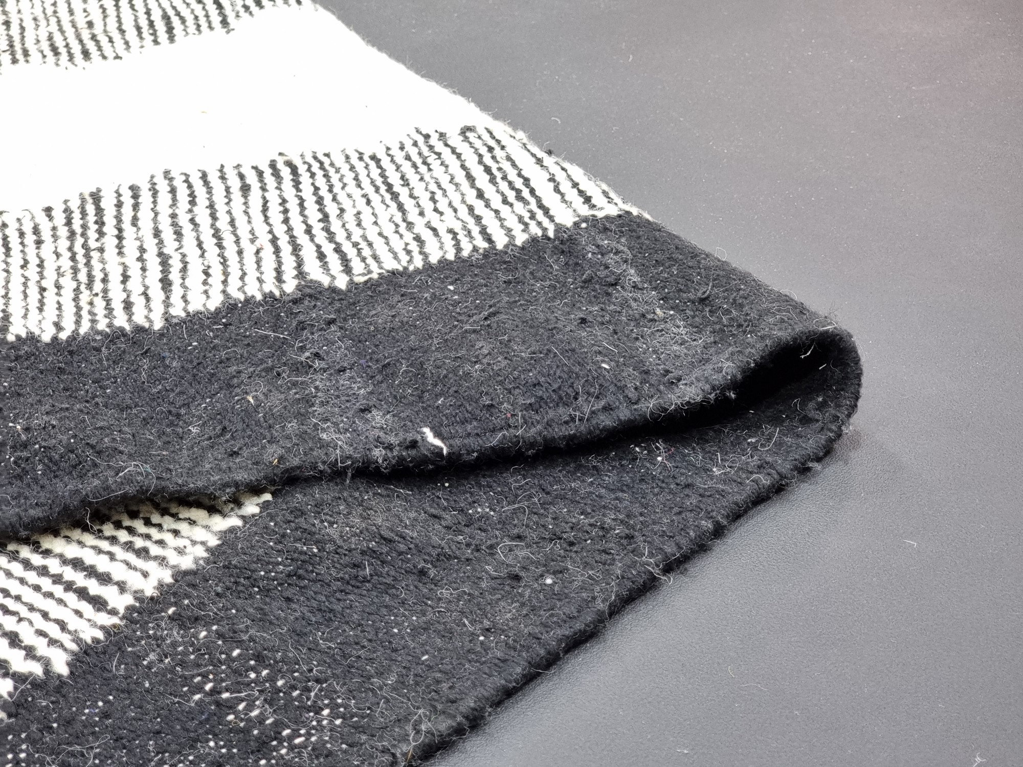 Handmade black and white geometric tassel rug - Image 3