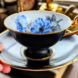 Black-glazed blue-flowered gilt cup and saucer set