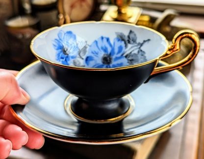 Black-glazed blue-flowered gilt cup and saucer set