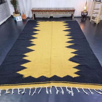 Black and yellow contrasting zigzag tassel rug