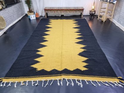 Black and yellow contrasting zigzag tassel rug