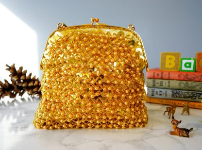 Luxurious gold hand-beaded lock bag