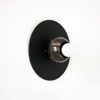 Black round marble cup and white bulb wall lamp