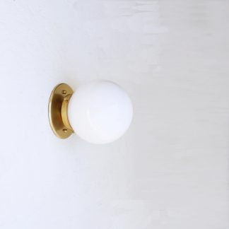 Brass rosette base and opaline globe wall lamp