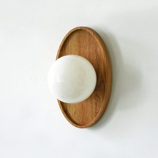Oval wooden panel and opaline glass globe wall lamp