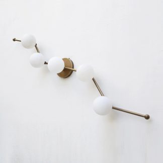 Brass rail and five opal sphere wall lamp
