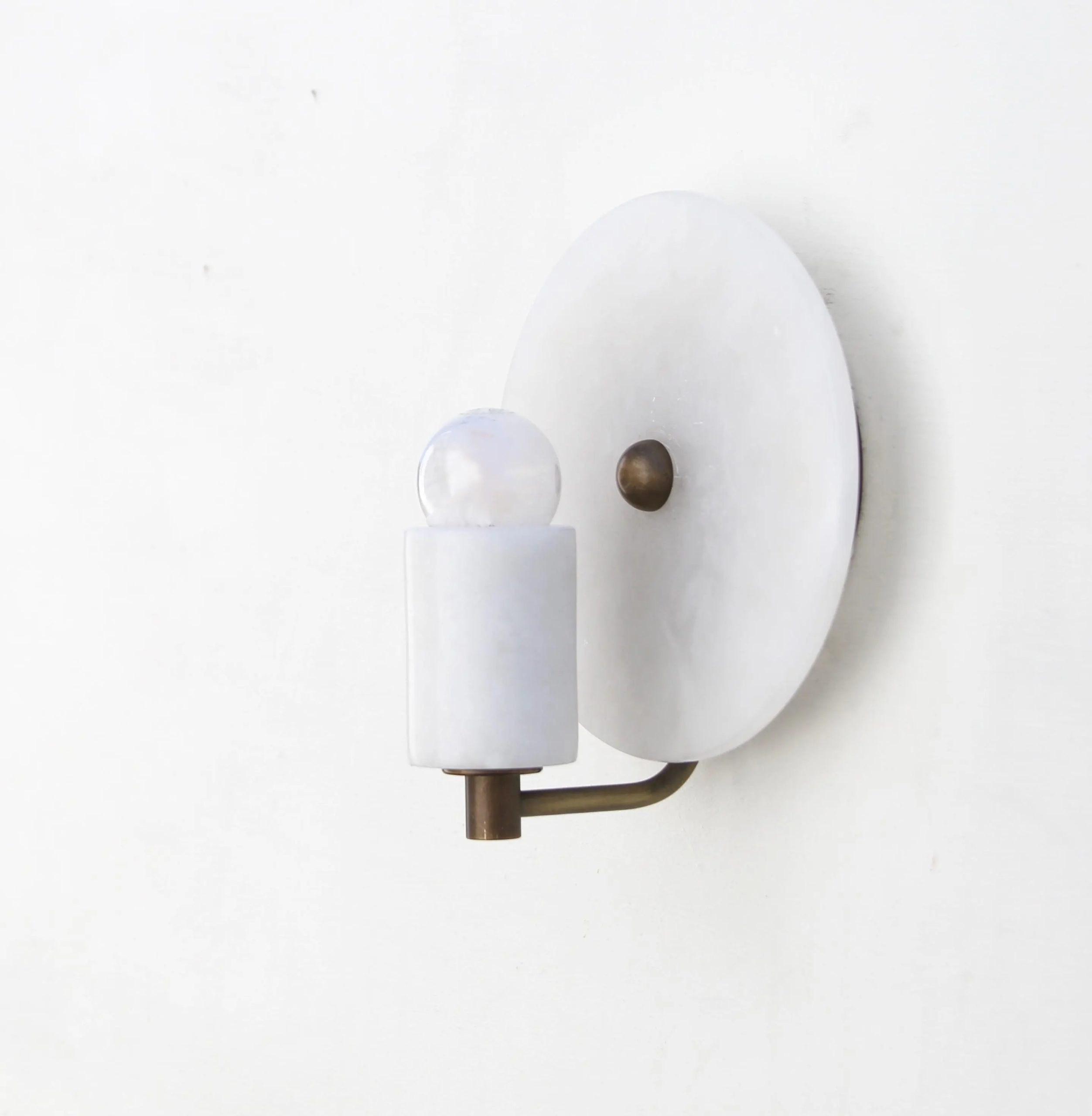 Brass arm and alabaster cylindrical wall lamp