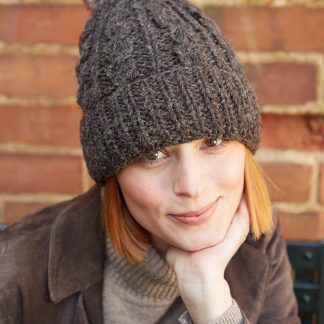 Cocoa-colored cable knit hat with pom-poms