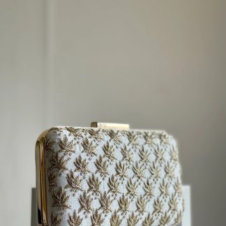 Ivory-colored gold leaf embroidered clutch