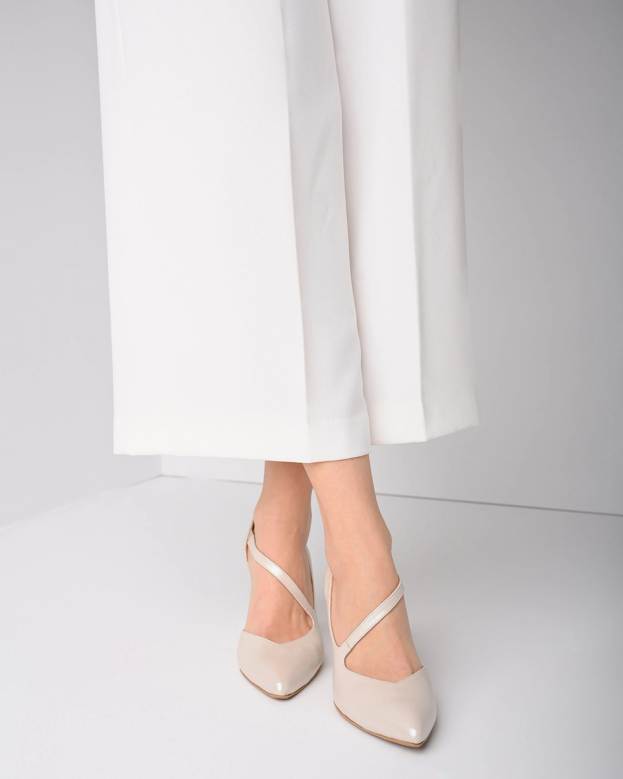 Porcelain white asymmetrical strappy chunky heels