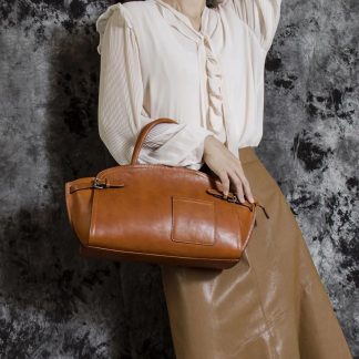 Caramel-colored curved wing-shaped handbag